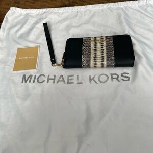 Michael Kors Black with snake print center and gold hardware.